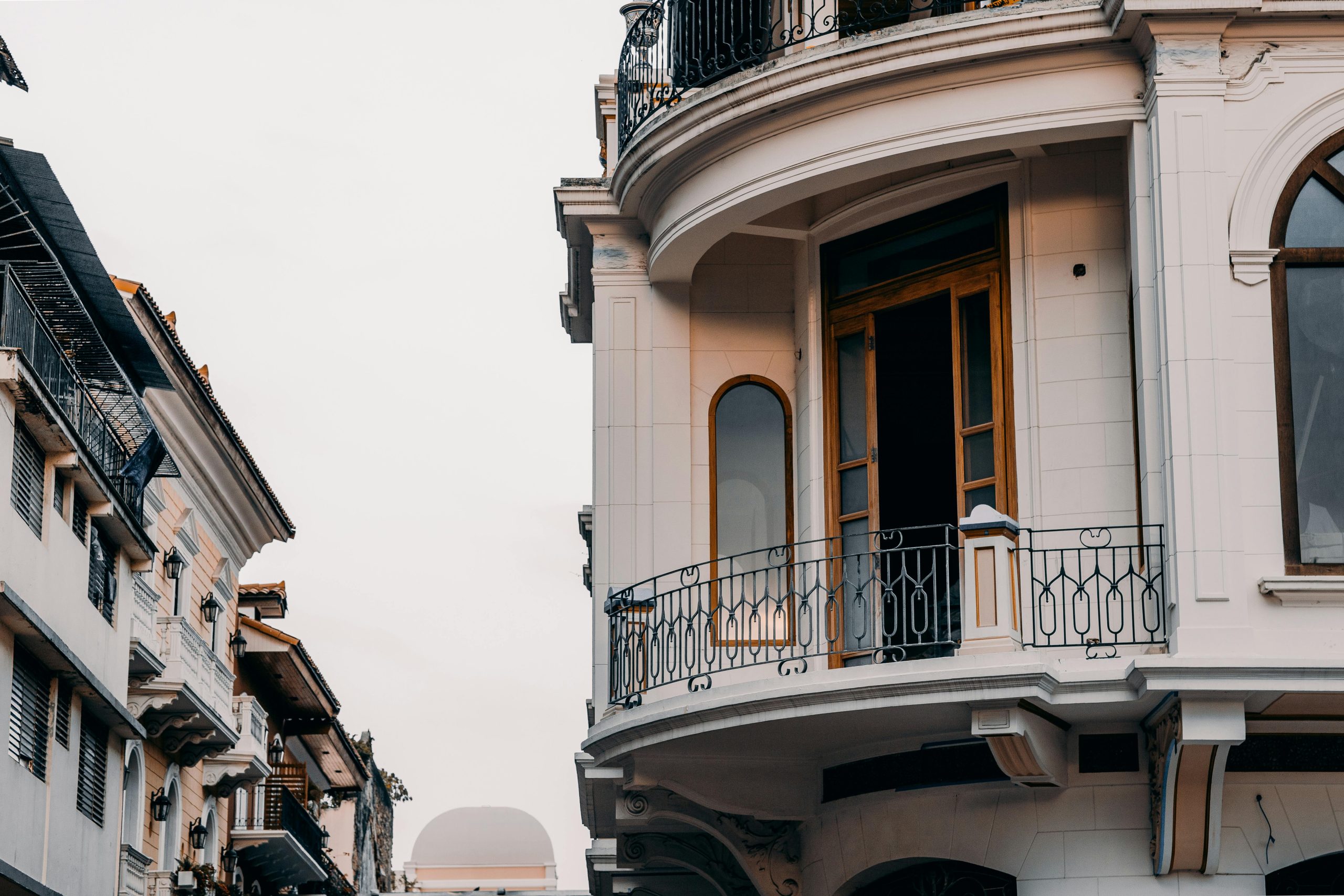 Home Stylish building facade with intricate balcony design, illustrating urban architecture and elegance.